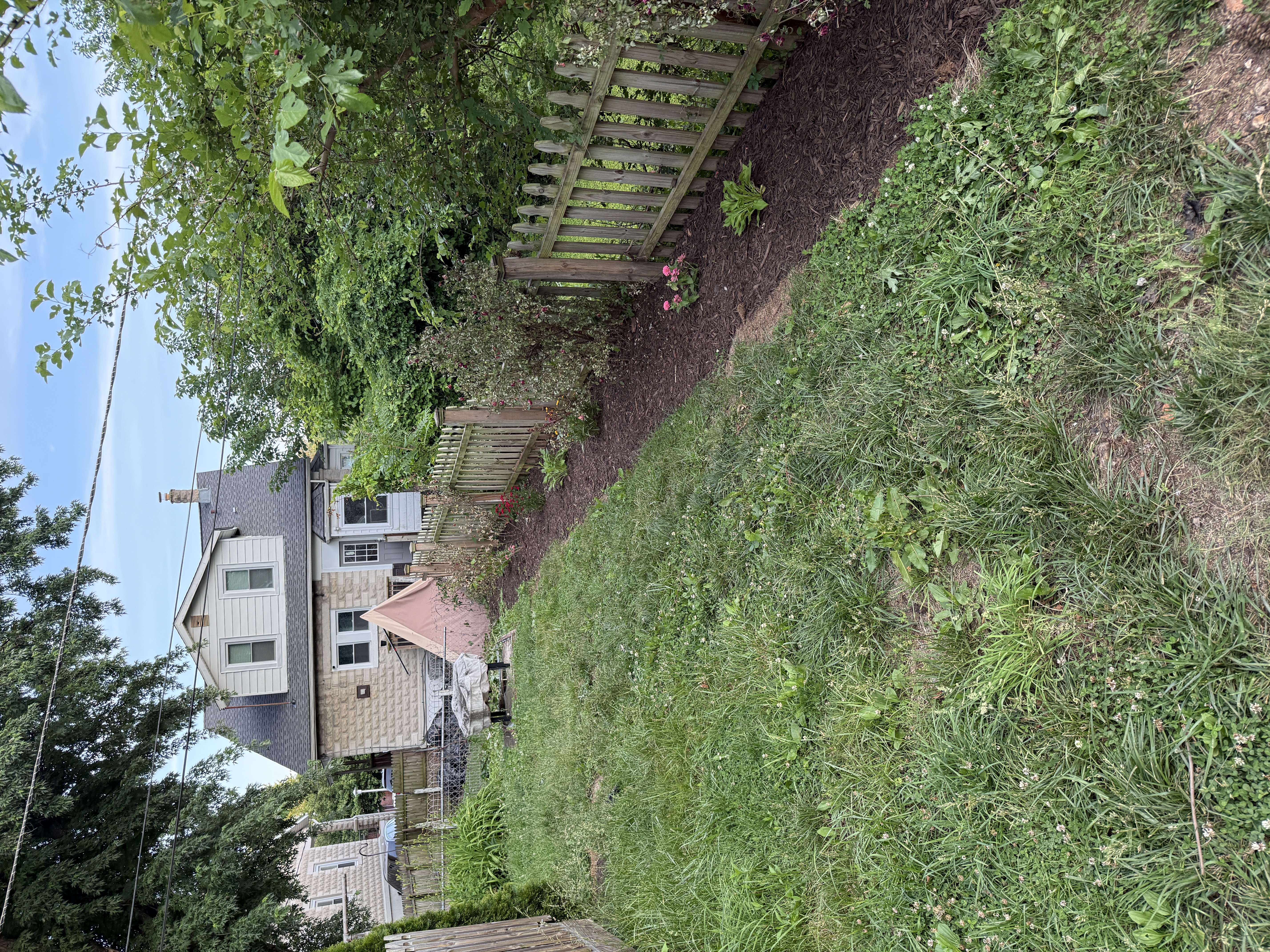 New picket fence installed with clean landscape behind it