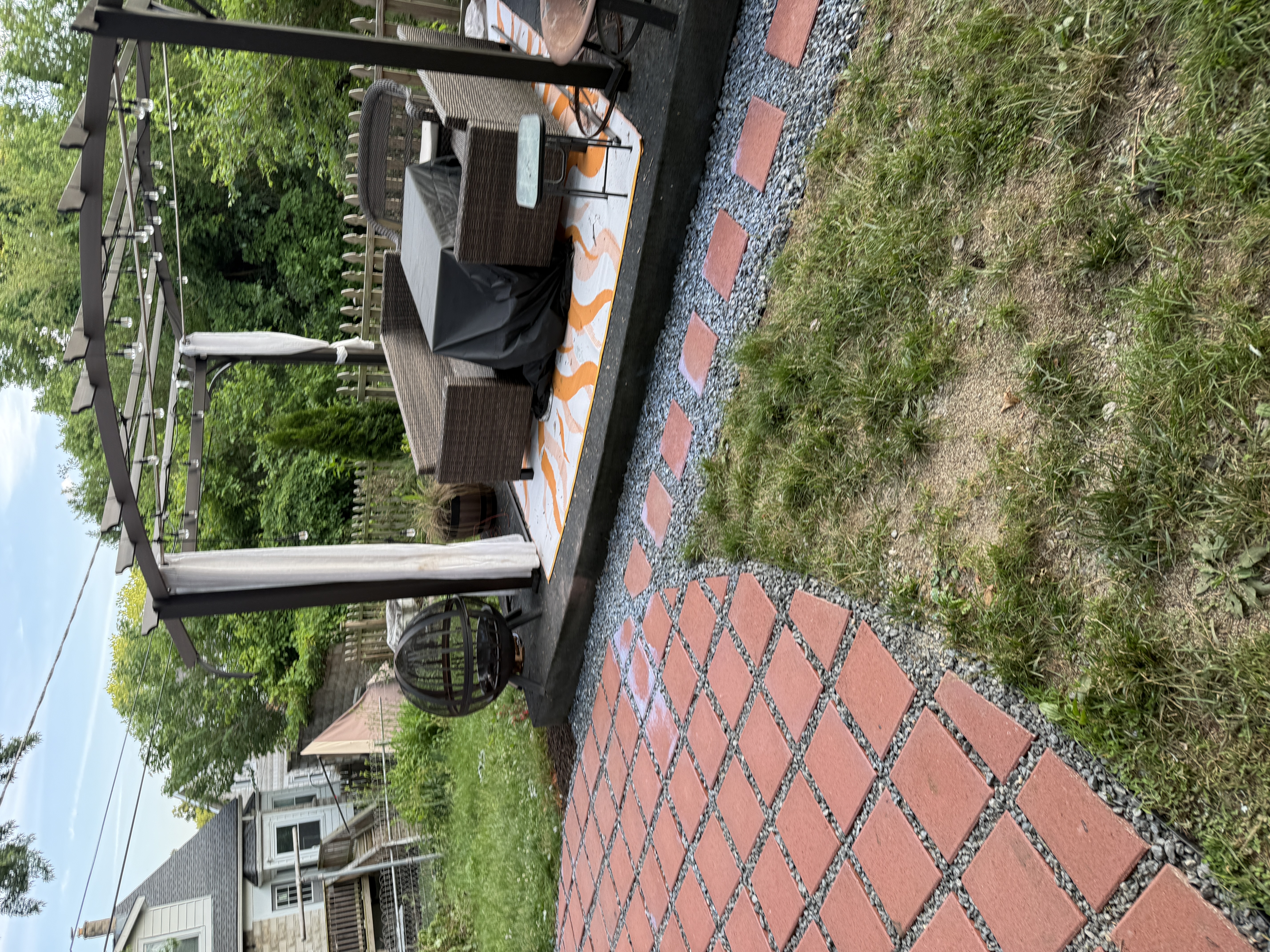 Finished paver patio with pergola and outdoor seating area